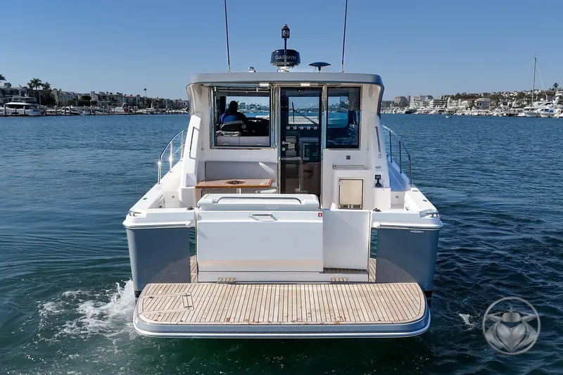 Slide: The Image of 2026 Riviera 395 SUV yacht cruising in a marina, rear view. - 10