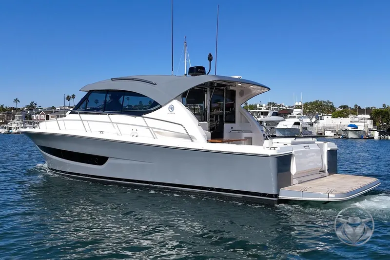 Slide: The Image of 2026 Riviera 395 SUV cruising on a sunny day in a marina setting. - 2