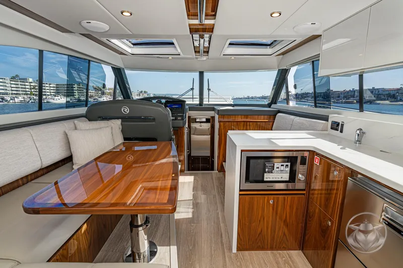 Slide: The Image of Luxurious interior of 2026 Riviera 395 SUV yacht with modern kitchen and seating area. - 25