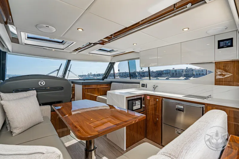 Slide: The Image of Luxurious interior of 2026 Riviera 395 SUV yacht with modern kitchen and seating area. - 27