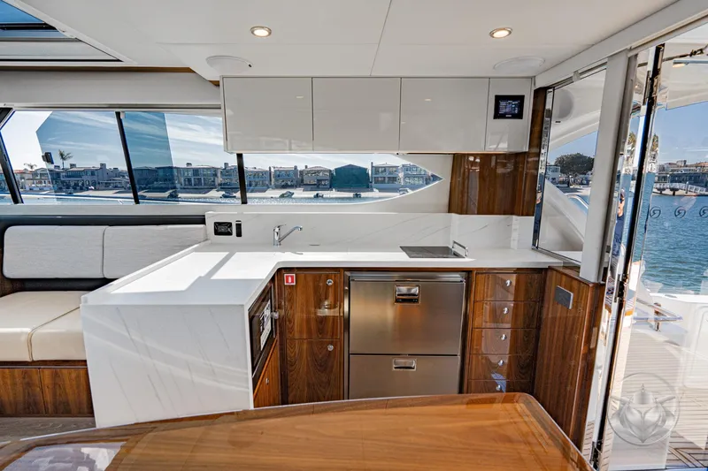 Slide: The Image of Luxurious interior of 2026 Riviera 395 SUV yacht with modern kitchen and waterfront view. - 28