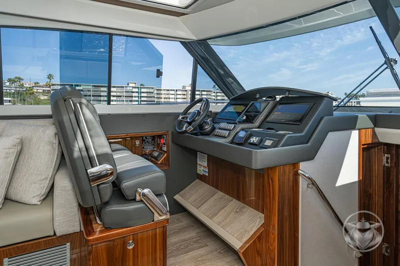 Slide: The Image of Interior helm of 2026 Riviera 395 SUV yacht with modern controls and luxurious seating. - 29