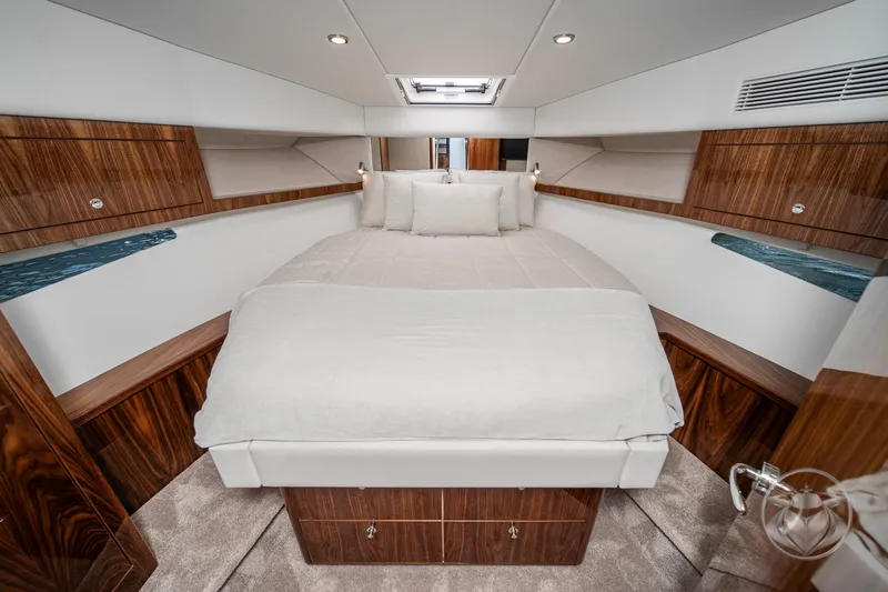 Slide: The Image of Luxurious interior cabin of 2026 Riviera 395 SUV yacht with elegant wood finishes. - 33