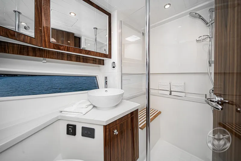 Slide: The Image of Luxurious bathroom interior of 2026 Riviera 395 SUV yacht with modern fixtures and wood accents. - 35