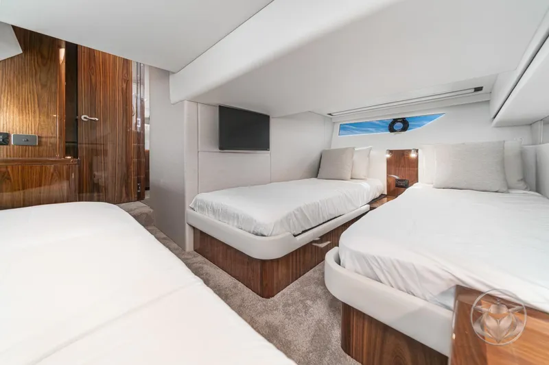 Slide: The Image of Luxurious interior of 2026 Riviera 395 SUV yacht with twin beds and modern decor. - 36