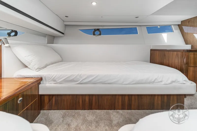 Slide: The Image of Luxurious interior of 2026 Riviera 395 SUV yacht with elegant wood finishes and comfortable bedding. - 37