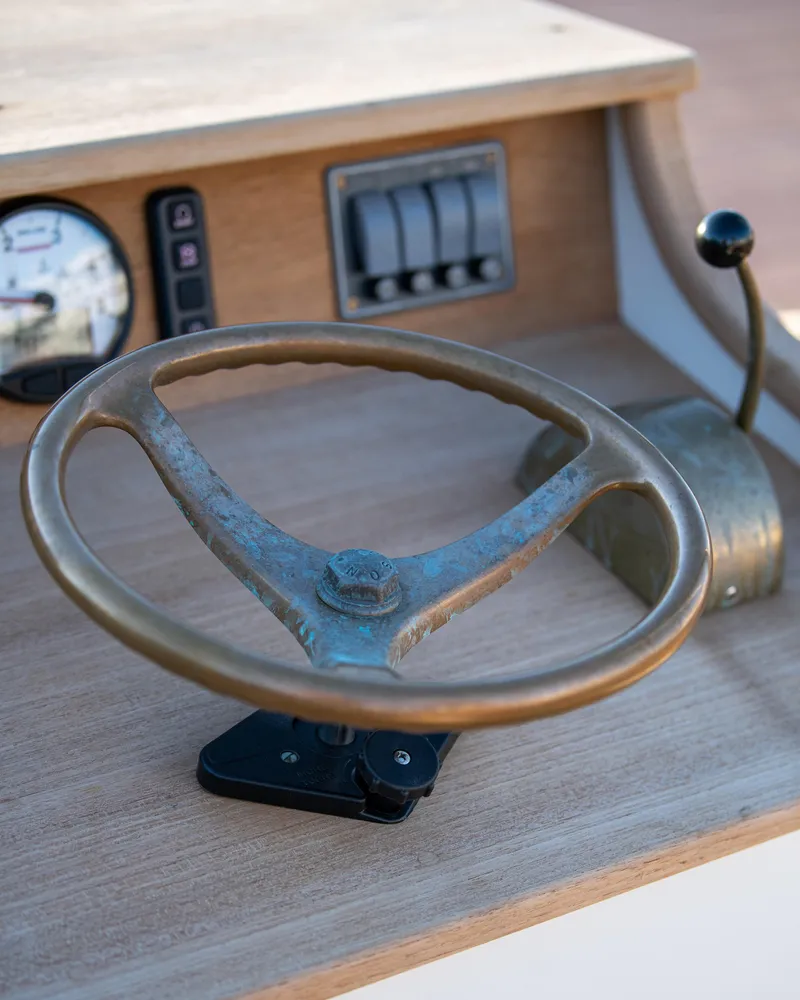 Slide: The Image of Steering wheel and controls of a 2021 Center Console East Passage 24 boat. - 16