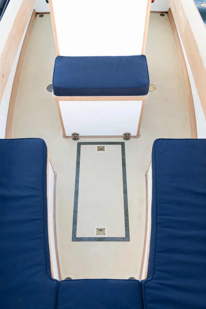 Slide: The Image of 2021 East Passage 24 Center Console boat interior with blue cushioned seating. - 18