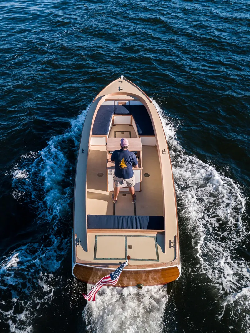 Slide: The Image of Aerial view of 2021 East Passage 24 Center Console boat cruising on water. - 3