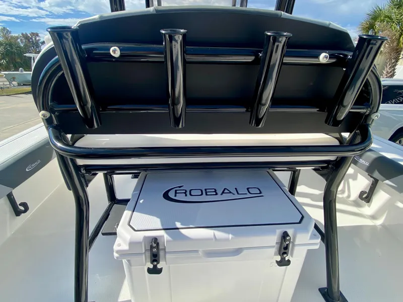 Slide: The Image of 2024 Robalo 226 Cayman boat with rod holders and cooler. - 11