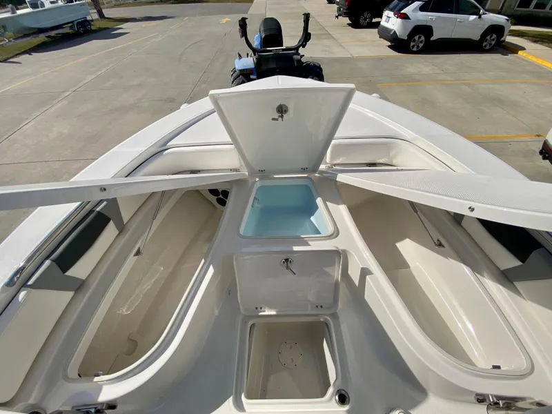 Slide: The Image of 2024 Robalo 226 Cayman boat with open storage compartments. - 21