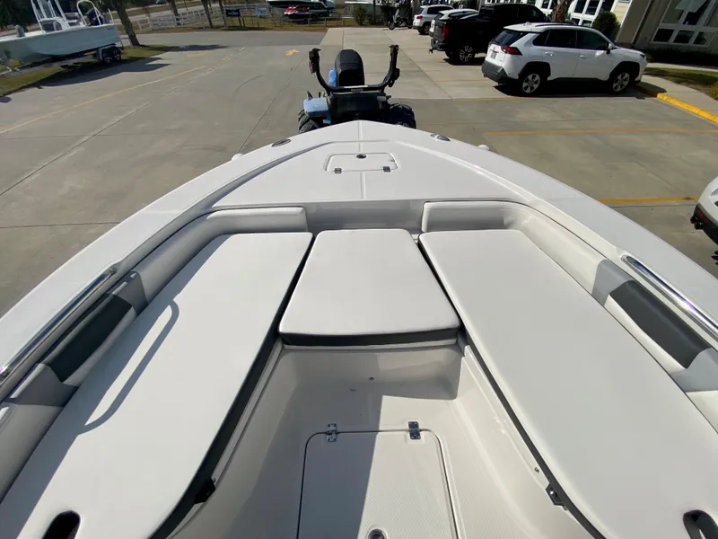 Slide: The Image of 2024 Robalo 226 Cayman boat bow seating area in a parking lot. - 22