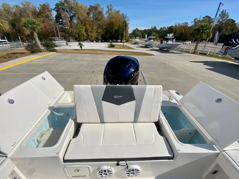 Slide: The Image of 2024 Robalo 226 Cayman boat rear seating and storage compartments. - 7