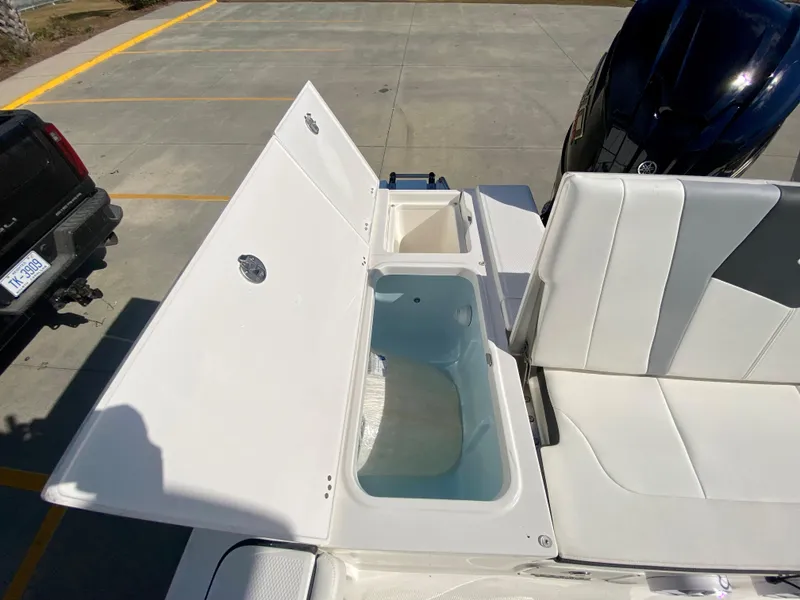 Slide: The Image of 2024 Robalo 226 Cayman boat with open storage compartments and seating. - 8