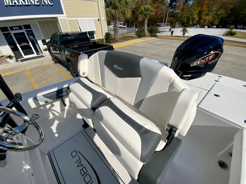 Slide: The Image of 2024 Robalo 226 Cayman boat with dual-tone seating and powerful outboard motor. - 12
