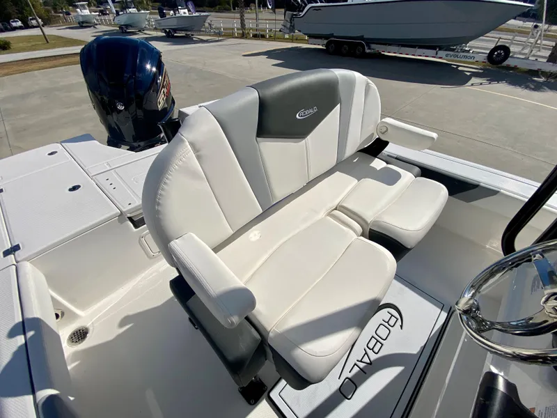 Slide: The Image of 2024 Robalo 226 Cayman boat seating and console area. - 13