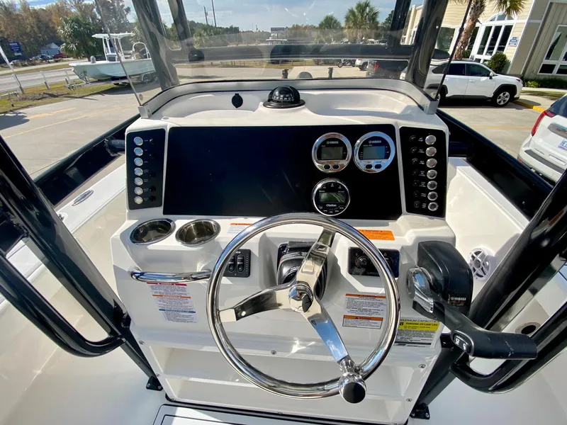 Slide: The Image of 2024 Robalo 226 Cayman boat console with steering wheel and instrument panel. - 14
