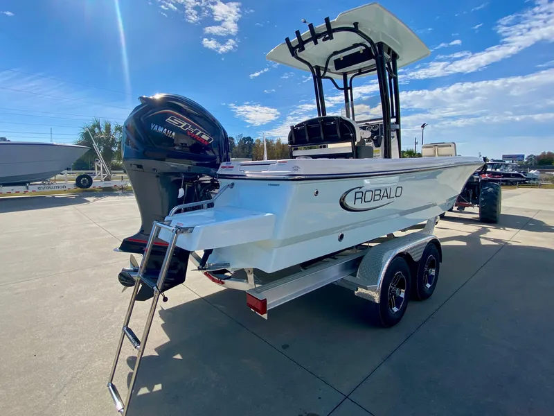 Slide: The Image of 2024 Robalo 226 Cayman boat on trailer with Yamaha outboard motor. - 2