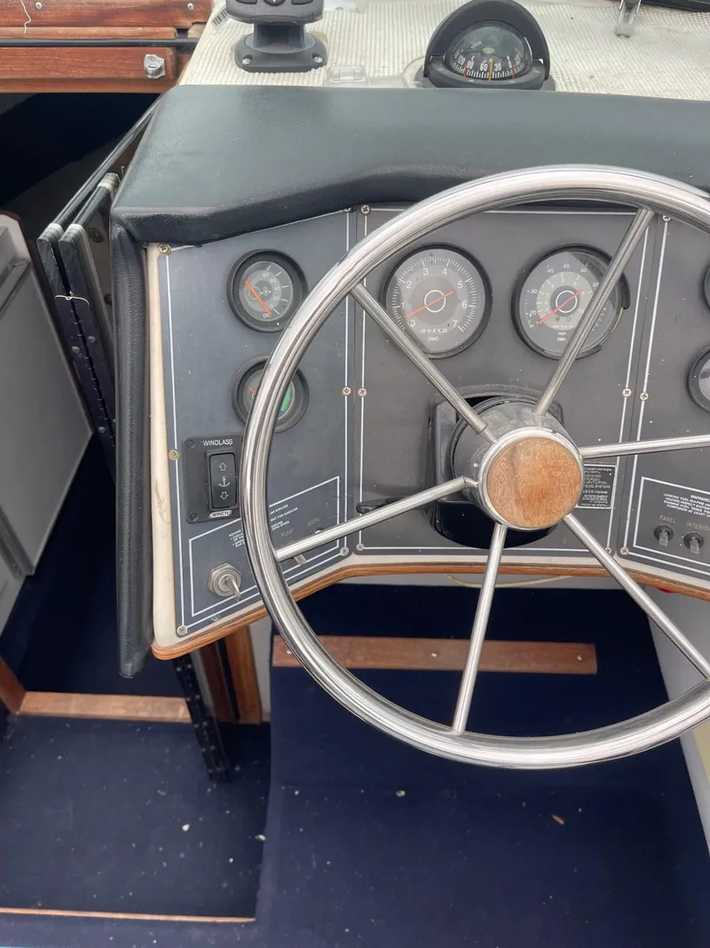Slide: The Image of 1988 Regal boat dashboard with steering wheel and gauges. - 10