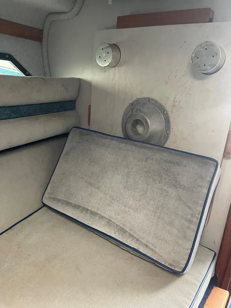 Slide: The Image of Interior of a 1988 Regal boat with cushioned seating and circular wall fixtures. - 14