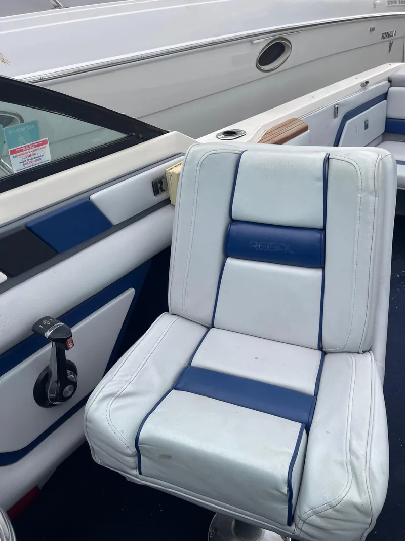Slide: The Image of 1988 Regal boat interior with white and blue seating. - 21