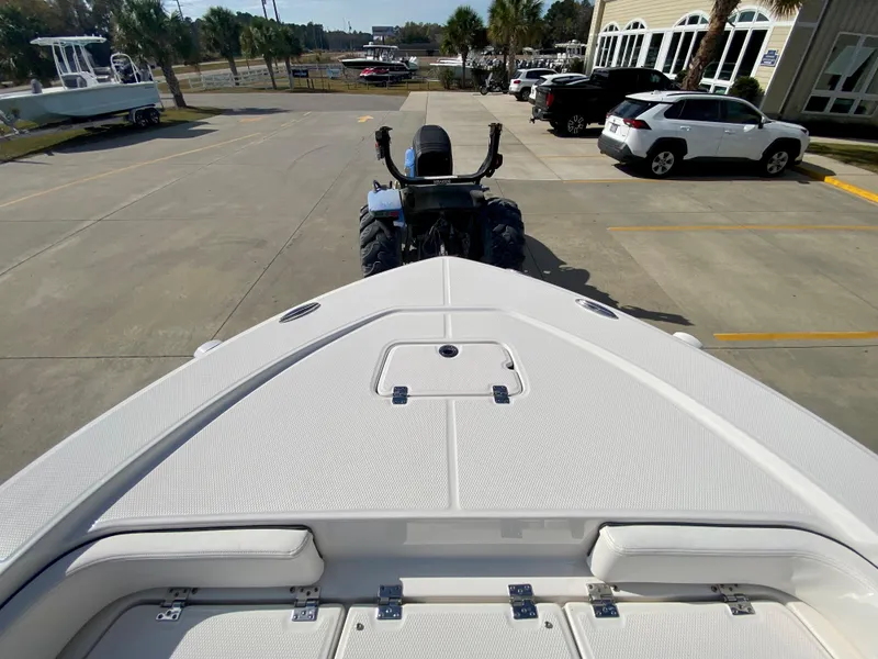Slide: The Image of 2024 Robalo 226 Cayman boat on trailer in parking lot. - 23