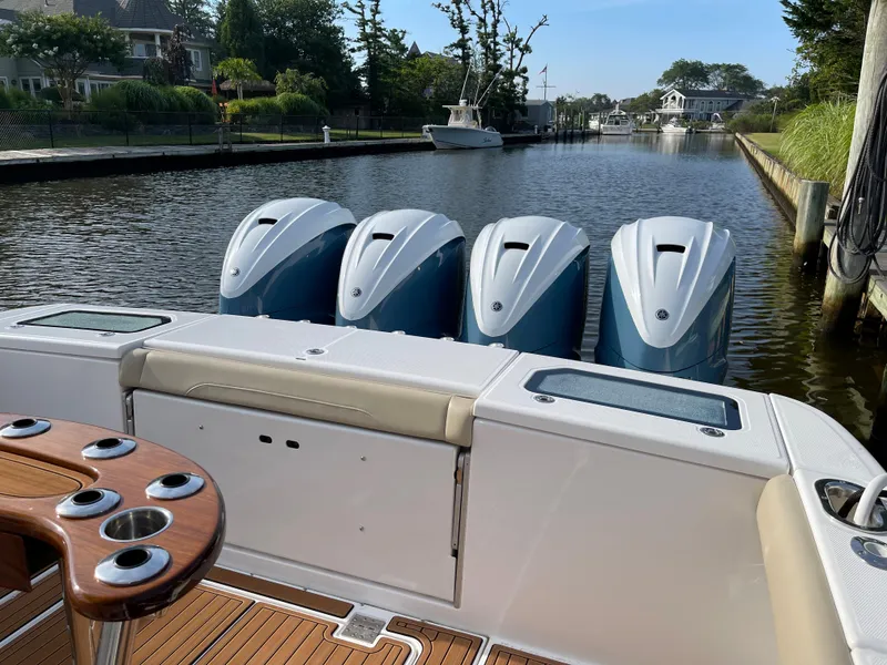 Slide: The Image of 2019 Everglades 435 CC boat with four powerful outboard engines on a calm waterway. - 11
