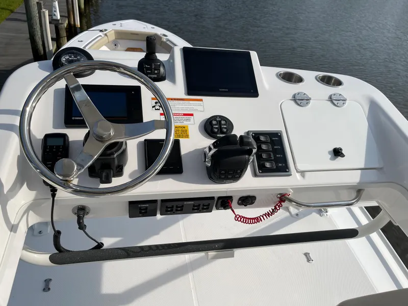 Slide: The Image of Control panel of a 2019 Everglades 435 CC boat with steering wheel and navigation screens. - 17