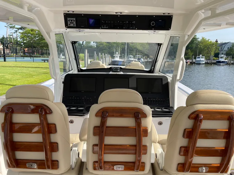 Slide: The Image of Interior view of 2019 Everglades 435 CC boat with luxurious seating and control panel. - 27