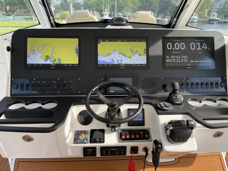 Slide: The Image of 2019 Everglades 435 CC boat dashboard with navigation screens and controls. - 29
