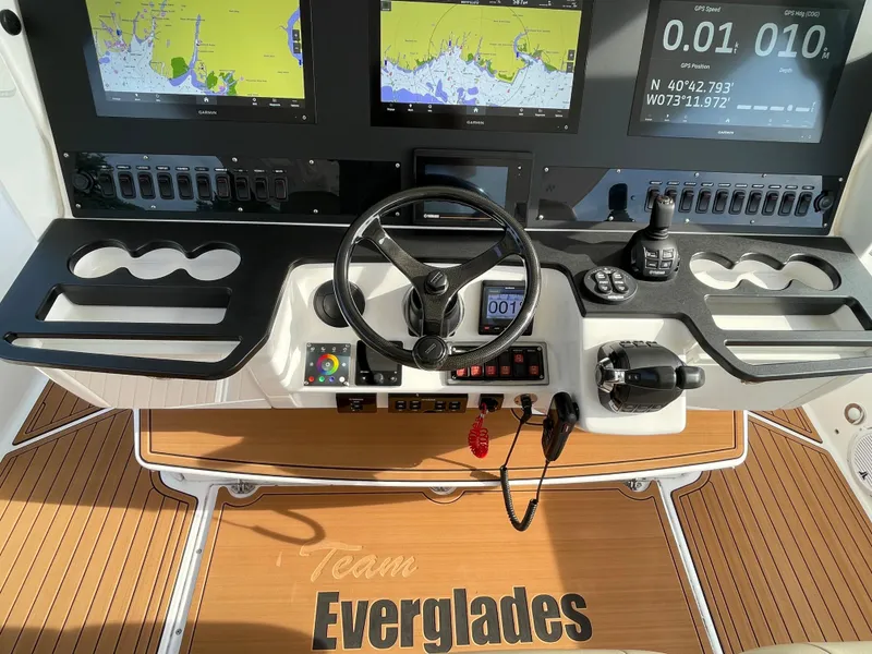 Slide: The Image of Control panel of 2019 Everglades 435 CC boat with navigation screens and steering wheel. - 30