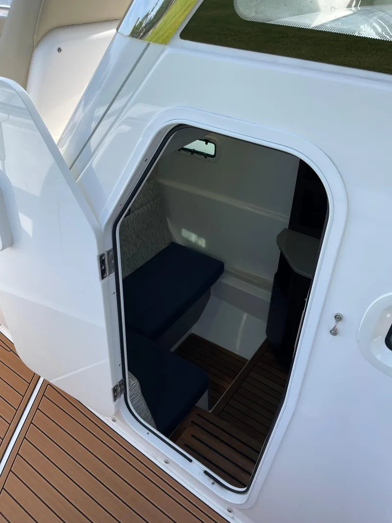 Slide: The Image of 2019 Everglades 435 CC cabin interior with open door and seating area. - 37
