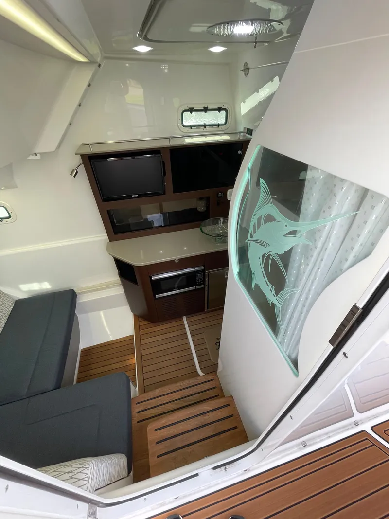 Slide: The Image of 2019 Everglades 435 CC cabin interior with modern design and wooden flooring. - 38