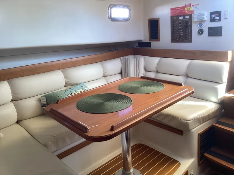 Slide: The Image of Interior of 2002 Mainship 34 PILOT with cozy seating and wooden table. - 15