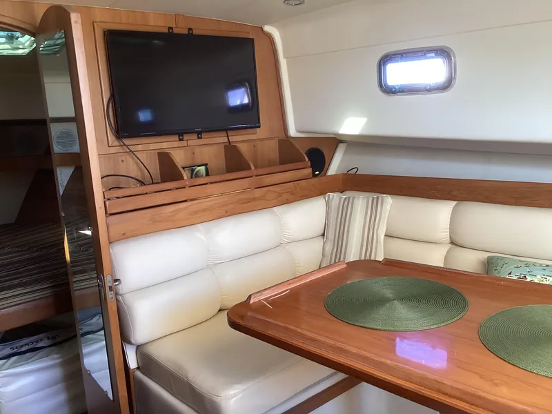 Slide: The Image of Interior of 2002 Mainship 34 PILOT with cozy seating and mounted TV. - 16