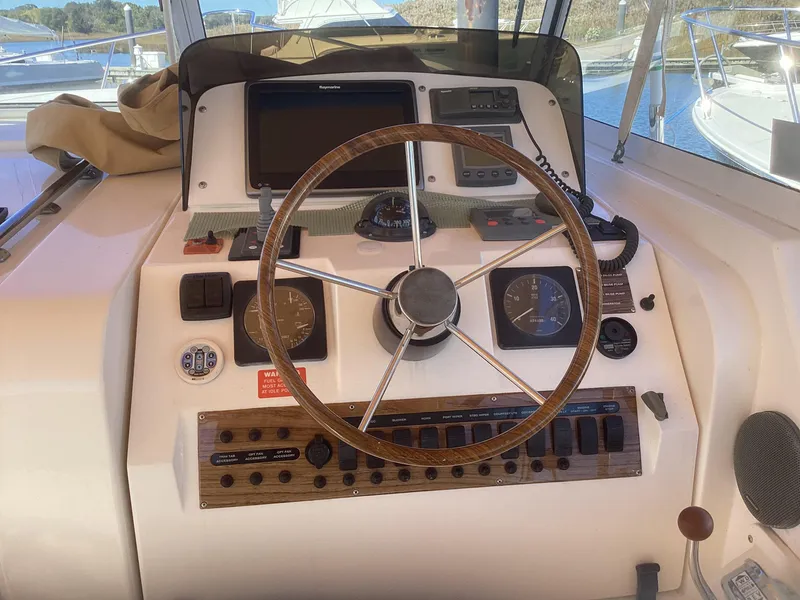 Slide: The Image of 2002 Mainship 34 PILOT helm with steering wheel and navigation instruments. - 7