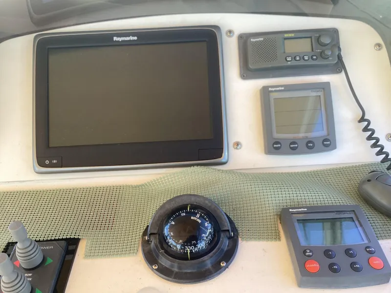 Slide: The Image of Mainship 34 Pilot 2002 dashboard with navigation instruments and compass. - 8