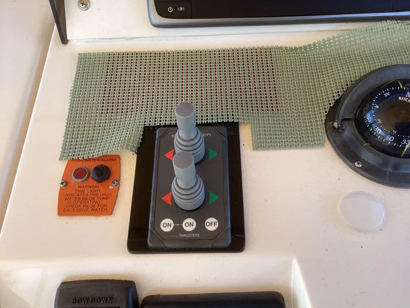 Slide: The Image of Control panel of 2002 Mainship 34 PILOT boat with joystick and compass. - 9