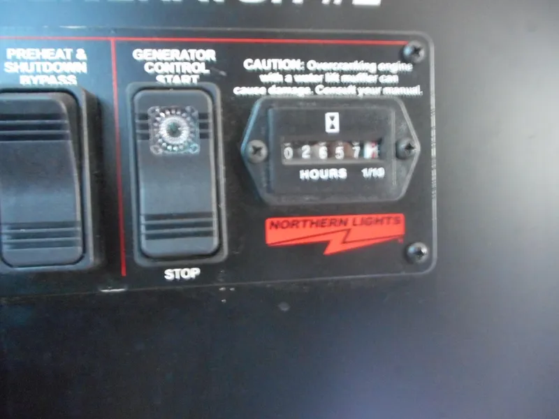 Slide: The Image of Control panel of Adonia Radiance Share #12, 2022 model, showing generator hours and caution label. - 14