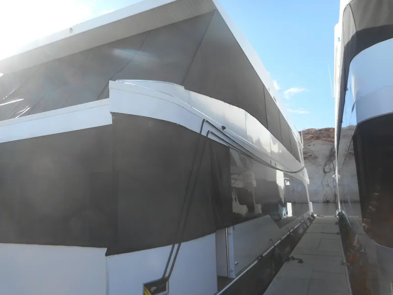 Slide: The Image of Modern Adonia Radiance Share #12 houseboat, 2022 model, docked under clear blue sky. - 2