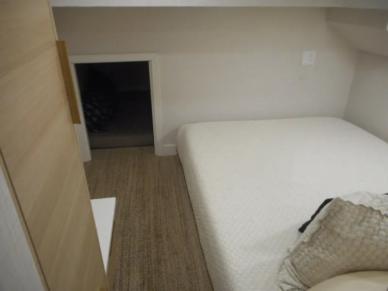 Slide: The Image of Compact bedroom in Adonia Radiance Share #12, 2022 model, featuring minimalist design and cozy bedding. - 29