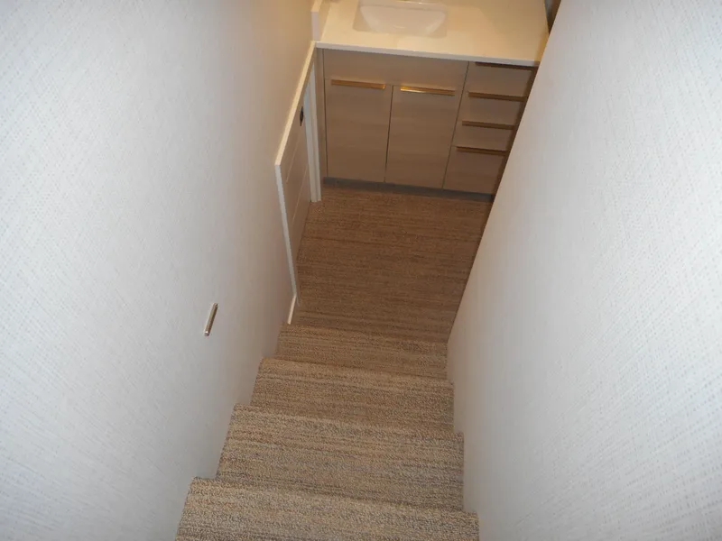 Slide: The Image of Narrow staircase leading to a small bathroom with wooden cabinets, Adonia Radiance Share #12, 2022. - 30