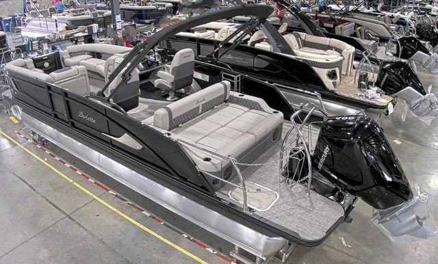 Slide: The Image of 2024 Barletta Boats Lusso 25UC pontoon boat in showroom. - 2