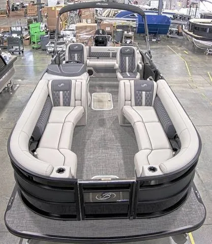 Slide: The Image of 2024 Barletta Boats Lusso 25UC pontoon boat with luxurious seating in a showroom. - 6