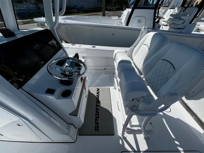 Slide: The Image of 2024 Sportsman Open 252 Center Console boat interior with steering wheel and seating. - 11