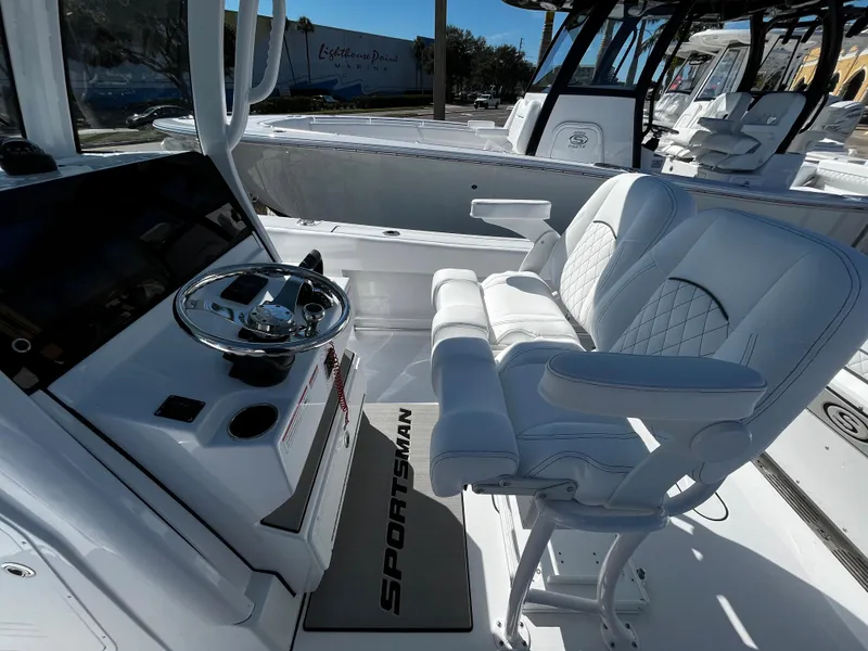 Slide: The Image of 2024 Sportsman Open 252 Center Console boat interior with helm and seating. - 12