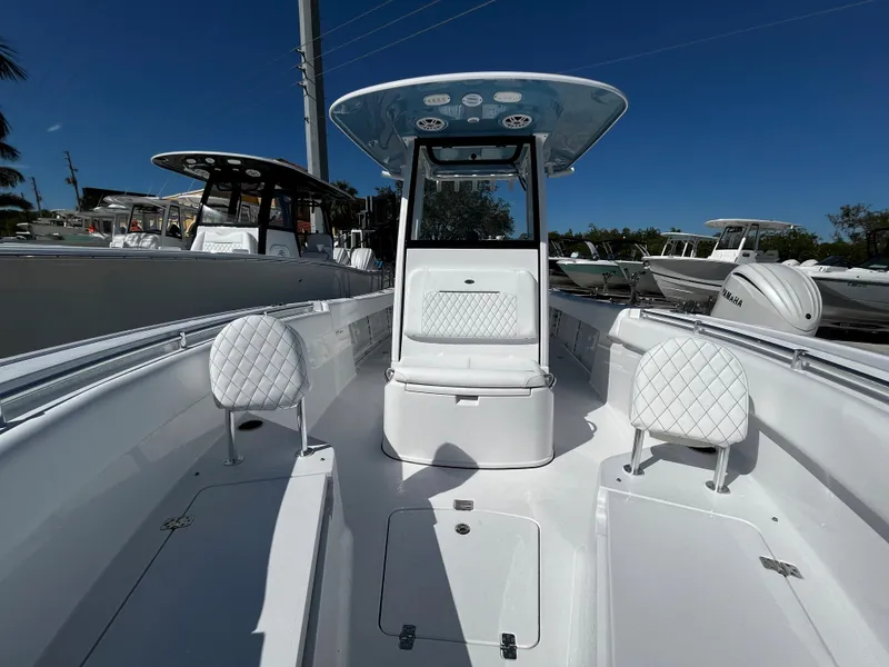 Slide: The Image of 2024 Sportsman Open 252 Center Console boat with white seating and T-top. - 19