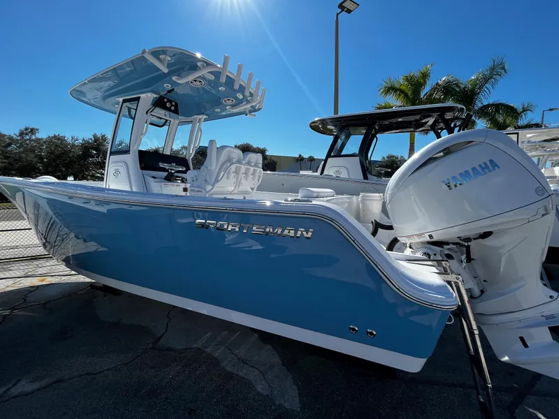 Slide: The Image of 2024 Sportsman Open 252 Center Console boat with Yamaha engine in marina. - 3