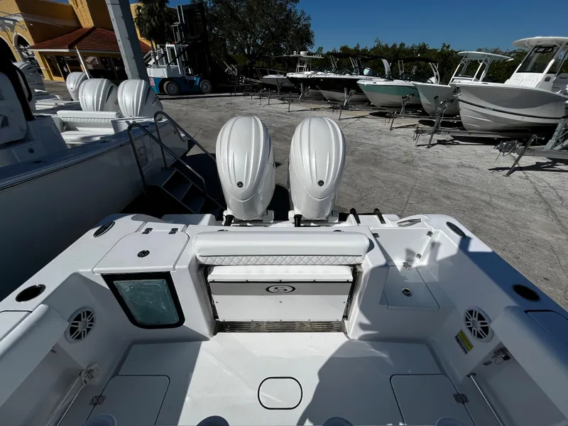 Slide: The Image of 2024 Sportsman Open 252 Center Console boat with dual engines in a marina. - 7