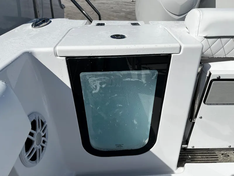 Slide: The Image of 2024 Sportsman Open 252 Center Console boat interior detail with storage compartment. - 8
